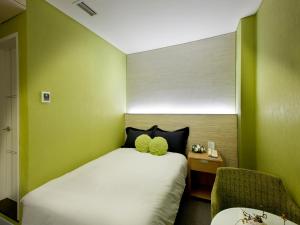 Кровать или кровати в номере Central Tourist Hotel