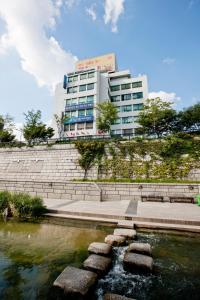 a building and a pond in front of a building at Central Tourist Hotel in Seoul