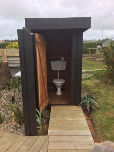 a bathroom with a toilet in a wooden door at Southern Scenic Stargazer in Riverton