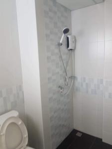 a bathroom with a shower stall with a toilet at PA House Apartment in Bangkok