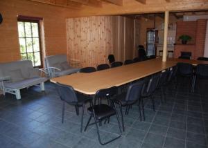 a large wooden table and chairs in a room at Laane Pansion in Käsmu