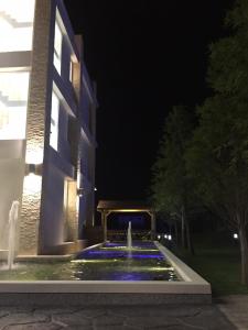 a fountain in front of a building at night at Xianel Vacation Chateau in Dahu
