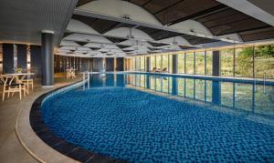 a large pool with blue water in a building at Pao's Sapa Leisure Hotel in Sa Pa