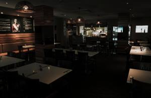 a restaurant with tables and chairs and a bar at General Roberts Hotel in New Lambton