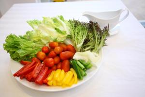 a plate of vegetables on a white table at New Space Hotel Airport in Ho Chi Minh City