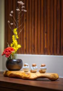 a table with four small ceramic figurines on it at The Sunbeam Hideaway B&B in Luodong +8 photos