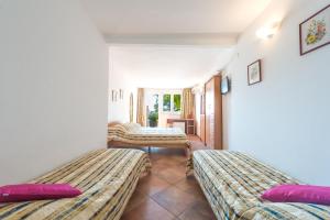 Posteľ alebo postele v izbe v ubytovaní Villa Carmen Rooms & Apartments + 37 fotografií
