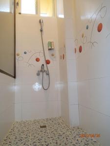 a bathroom with a shower with a shower head at Flower Tamura in Guanshan