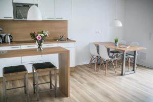 una cocina con mesa, sillas y una mesa con flores en Haus NordQuartier, en Norderney