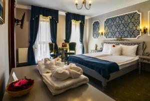 
a hotel room with a large bed and a large window at Rosen Villa Sibiu in Sibiu
