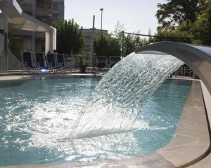 a water fountain in a swimming pool at Acapulco Hotel in Cattolica