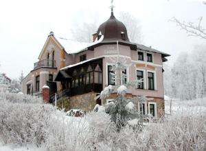 a large house is covered in snow at Villa Ludmila in Janske Lazne