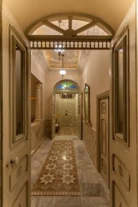 a hallway of a home with a door and a rug at Maison d'Hôtes Dar Ennassim in La Marsa