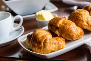 a plate of pastries on a table with a cup of coffee at The Castle Inn Hotel by BW Signature Collection, Keswick in Keswick