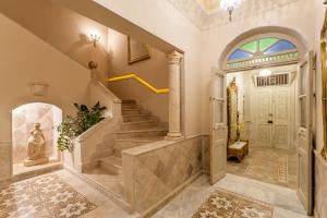 a foyer with a staircase and a white door at Maison d'Hôtes Dar Ennassim in La Marsa