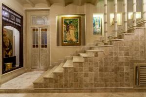 a staircase in a home with paintings on the wall at Maison d'Hôtes Dar Ennassim in La Marsa