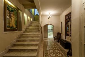 a staircase in a building with a painting on the wall at Maison d'Hôtes Dar Ennassim in La Marsa