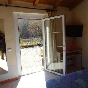 a sliding glass door with a view of a patio at Agriturismo Campo dei Fiori in Rancio Valcuvia