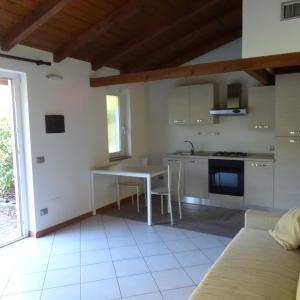 a kitchen with a table and a couch in a room at Agriturismo Campo dei Fiori in Rancio Valcuvia