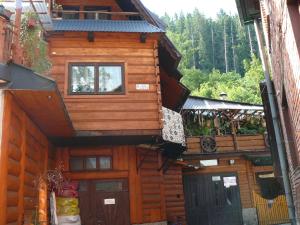 a wooden house with a balcony on the side of it at Wynajem Pokoi Krystyna Mróz in Zakopane