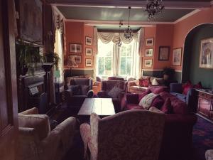 a living room with couches and a table at The Old Dungeon Ghyll Hotel in Great Langdale