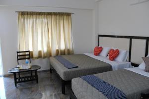 Postel nebo postele na pokoji v ubytování Hotel Jaidharshini Palace