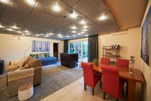 a living room with a table and a couch at Harlingen Garden Apartment in Midlum +40 photos