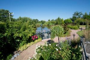 an aerial view of a garden with a lake at Harlingen Garden Apartment in Midlum +13 photos