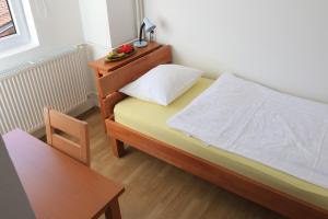 Postel nebo postele na pokoji v ubytování Pansion Centar