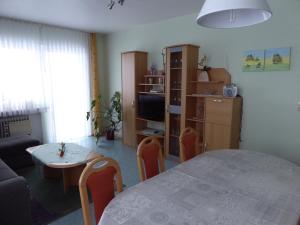 a living room with a table and a living room with a couch at Ferienwohnung Treuter in Viereth-Trunstadt