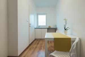 a white room with a table with a box on it at Camelia's cozy place in Baia Mare