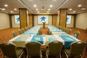 a conference room with long tables and chairs and a podium at White Star Hotel in Adıyaman +43 photos