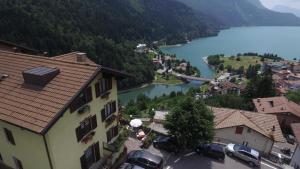 a view of a town with a lake and mountains at Hotel Aurora in Molveno +142 photos