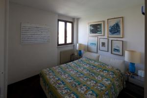 a bedroom with a bed and pictures on the wall at Old Harbour House in Grado