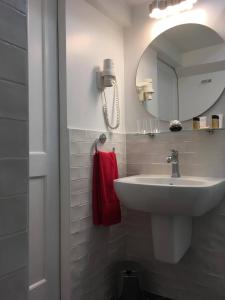 a white bathroom with a sink and a mirror at Dubrovnik Hotel Alternatives in Dubrovnik