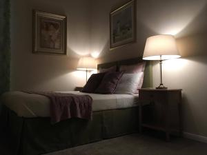 a bedroom with a bed with two lamps on it at Dubrovnik Hotel Alternatives in Dubrovnik