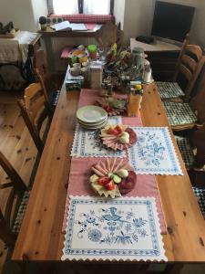 a wooden table with plates and dishes on it at Ubytování Hrusice in Hrusice