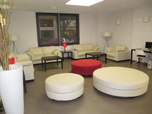 a waiting room with white couches and tables at Don Juan in Granada