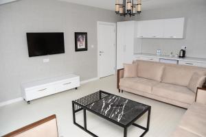 a living room with a couch and a coffee table at Gardenya Suite Hotel in Trabzon