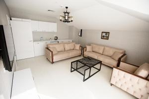 a living room with two couches and a table at Gardenya Suite Hotel in Trabzon