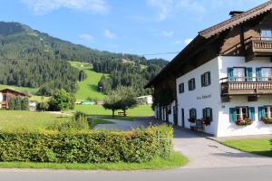 a building with a view of a mountain at Pension Klausnerhof in Westendorf