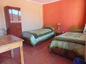 Postel nebo postele na pokoji v ubytování Hostal Coronel Pedro Arraya