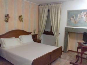 En eller flere senger på et rom på Hotel Ristorante La Bettola
