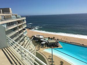 a view of the beach from the balcony of a resort at Duplex Jacuzzi San Alfonso del Mar in Algarrobo