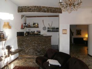 a living room with a couch and a brick fireplace at Hotel Due Pini in Baselga di Pinè