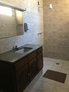 a bathroom with a sink and a shower at Pousada Santa Lolla in São Carlos +43 photos