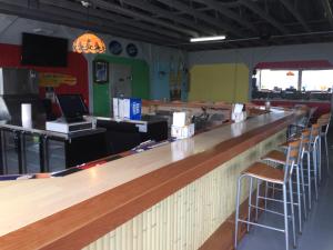 a bar in a restaurant with bar stools at Beachcomber Inn in Conesus