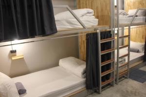 a room with bunk beds in a dorm room at Ekanek Hostel in Bangkok