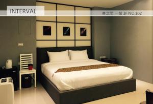 um quarto com uma cama grande com lençóis brancos em Interval em Wujie