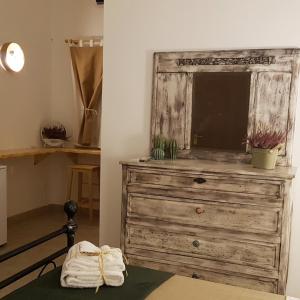 a wooden dresser with a tv on top of it at Tenuta Guarascio in Cavallino di Lecce +57 photos